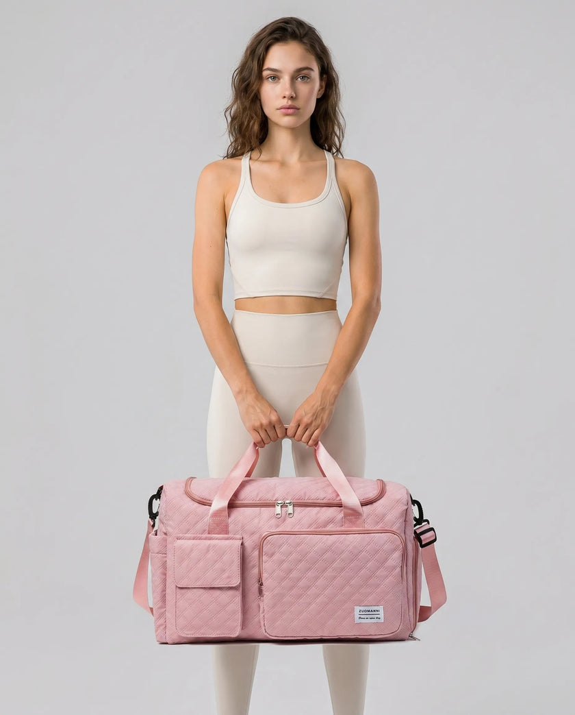 Model holding SoftForm Carry Bag in dusty pink styled for everyday and gym movement