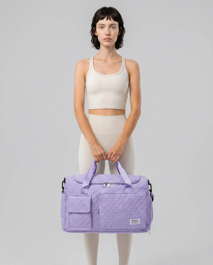 Model holding SoftForm Carry Bag in lavender styled for everyday and gym movement