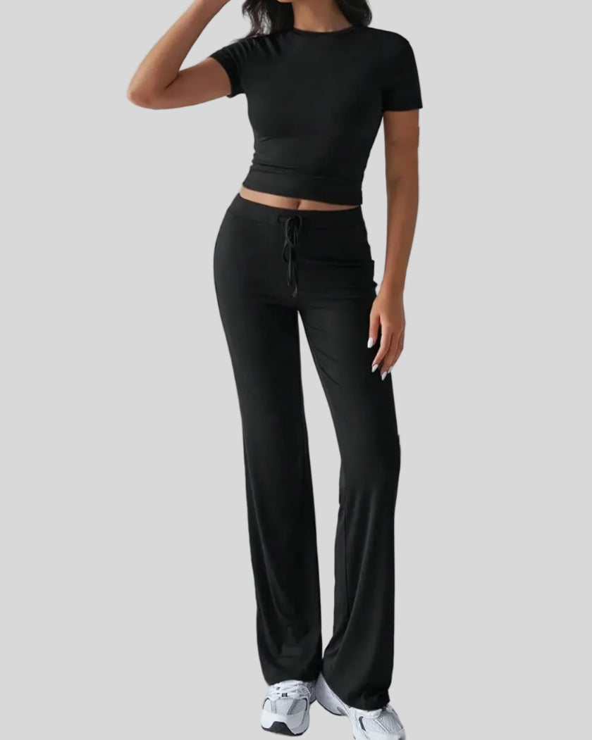 Front angled view of model wearing black Athlesi SoftForm lounge set