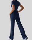 Back view of model wearing dark blue Athlesi SoftForm short sleeve top and pant set