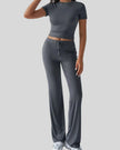 Front angled view of model wearing dark gray Athlesi SoftForm lounge set