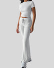 Model wearing light gray Athlesi SoftForm top and pant set second front angle