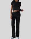 Model wearing black Athlesi SoftForm short sleeve top and pant set front view