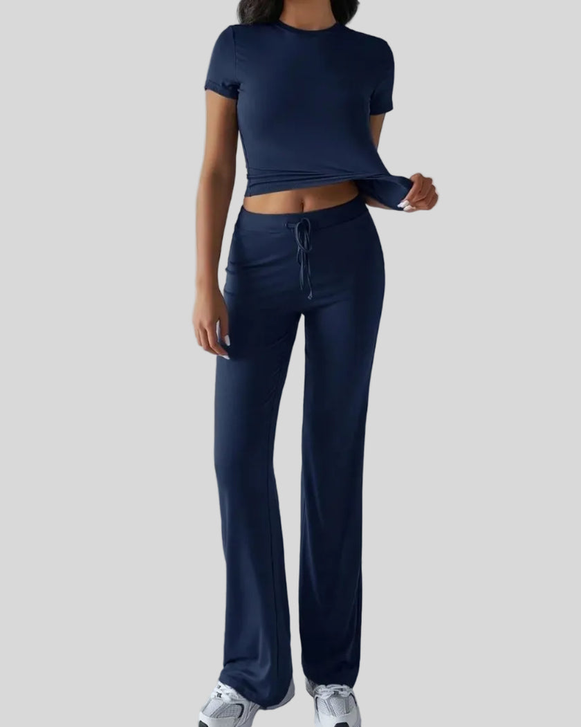Model wearing dark blue Athlesi SoftForm short sleeve top and pant set front view