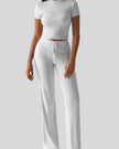 Model wearing light gray Athlesi SoftForm short sleeve top and pant set front view