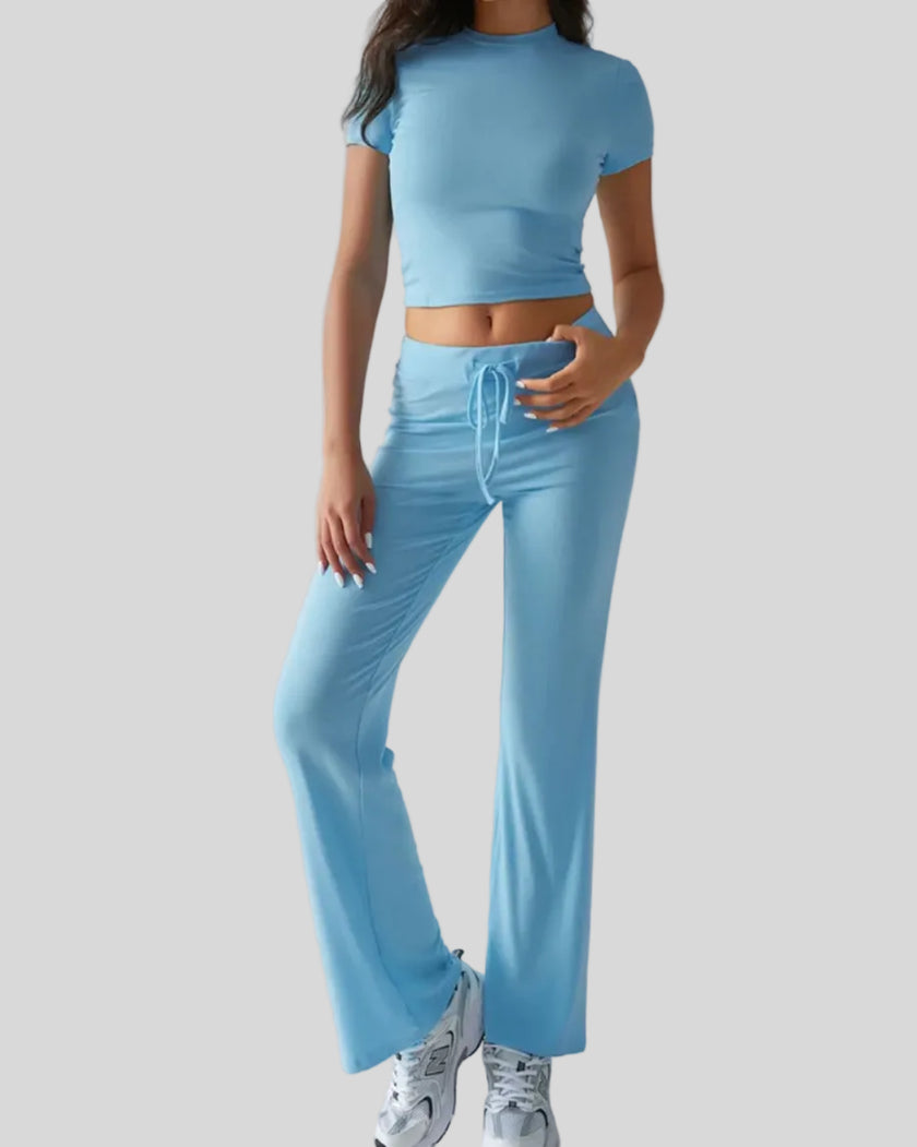 Model wearing pastel blue Athlesi SoftForm short sleeve top and pant set front view