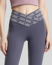 Closeup of “Magic Angel” slogan waistband on Statement Angel Legging in dark gray