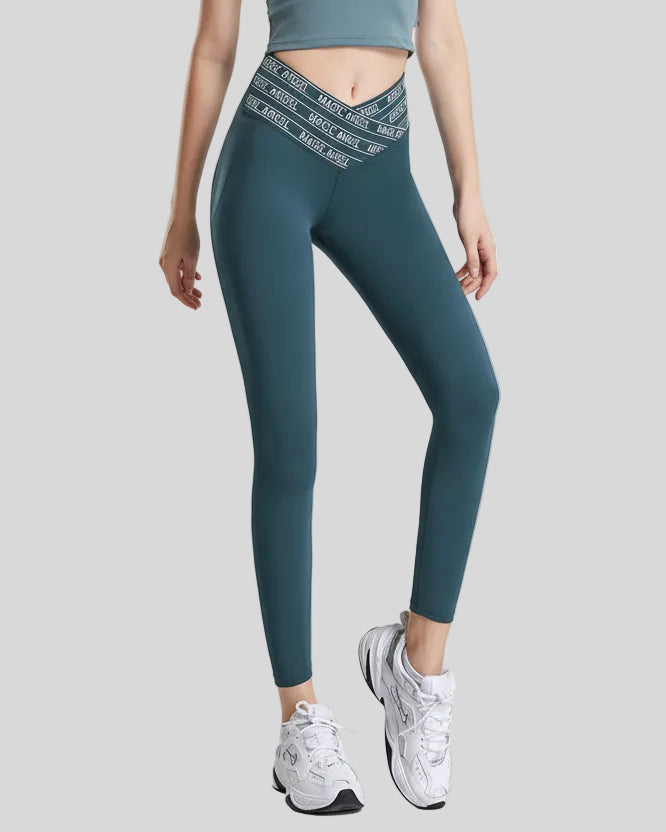 Front angle view of Statement Angel Legging in deep teal, showing bold waistband detail