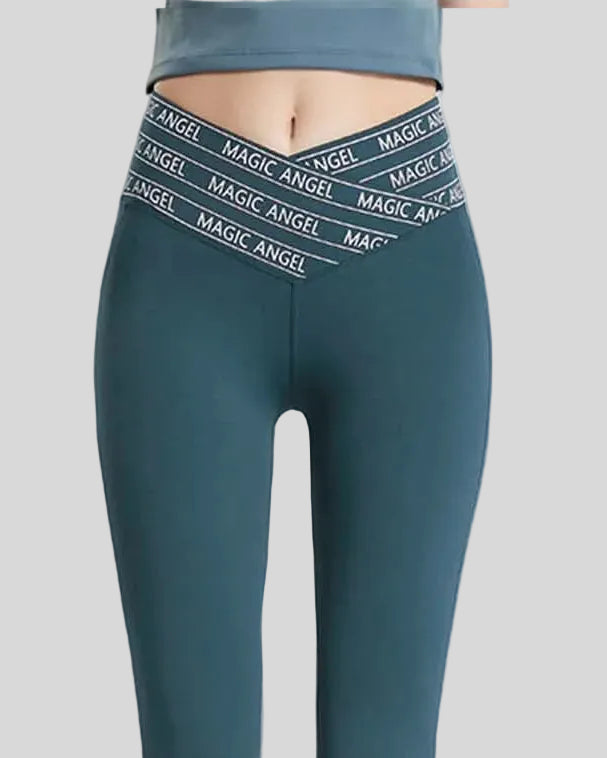 Front view of Statement Angel Legging in deep teal with slogan waistband