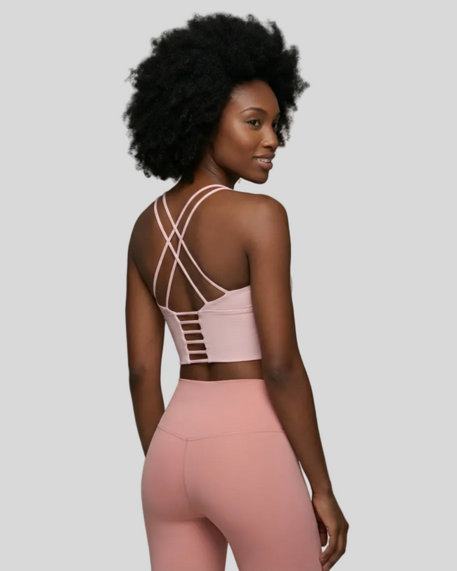 Back angle view of blush pink ladder strap sports bra with Athlesi pink leggings