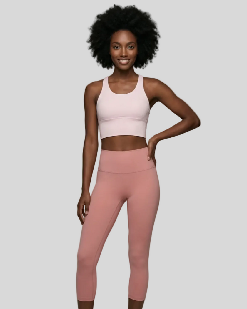 Blush pink StrataLuxe sports bra styled with matching Athlesi pink leggings front view