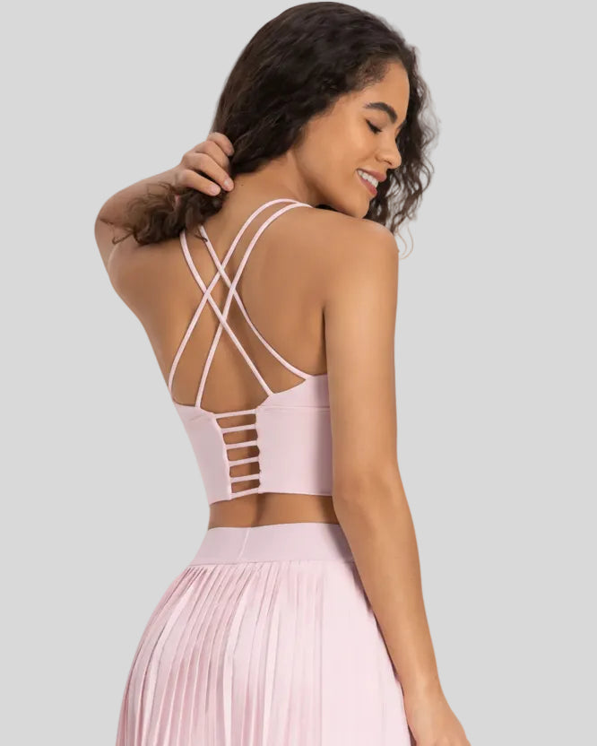 Back view of StrataLuxe blush pink sports bra with crisscross ladder straps