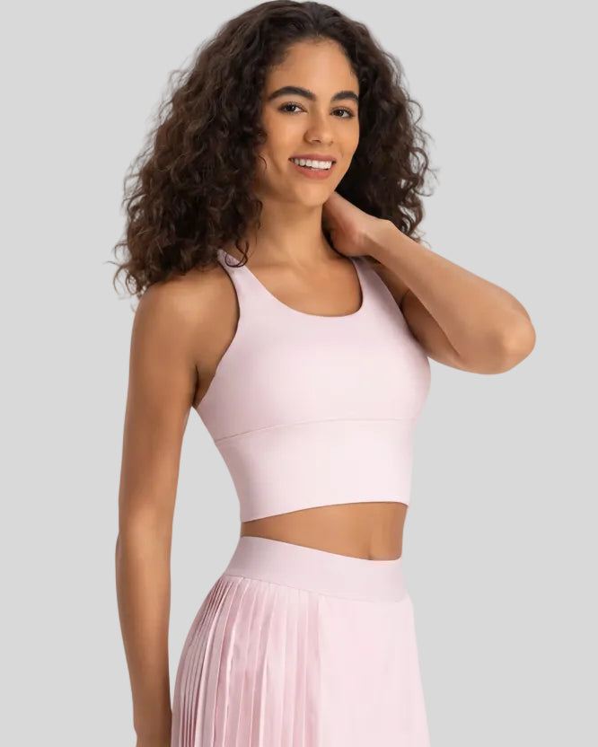 Angled front view of blush pink ladder back longline sports bra Athlesi