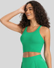 Angled front view of mid green ladder back longline sports bra Athlesi