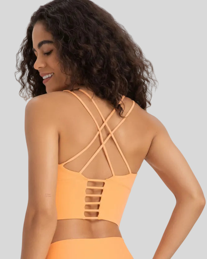 Back view of StrataLuxe sherbet sports bra with crisscross ladder straps