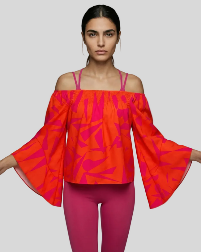StreetBloom off-shoulder blouse in orange styled with pink Athlesi leggings front view