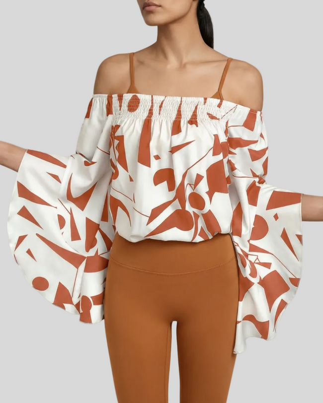 StreetBloom off-shoulder blouse in red orange styled with caramel Athlesi leggings front view