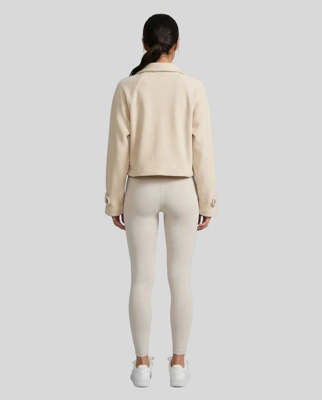 StructureForm Collared Jacket in sand worn by model full body back view showing silhouette and structure