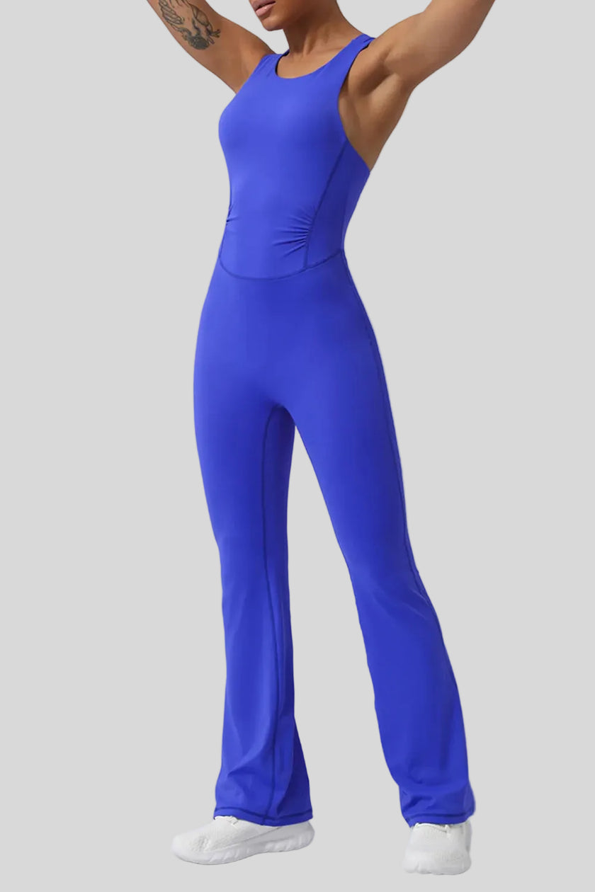 Athlesi StudioCross Sculpt & Flow Jumpsuit in blue showing fluid pant silhouette, front angle view