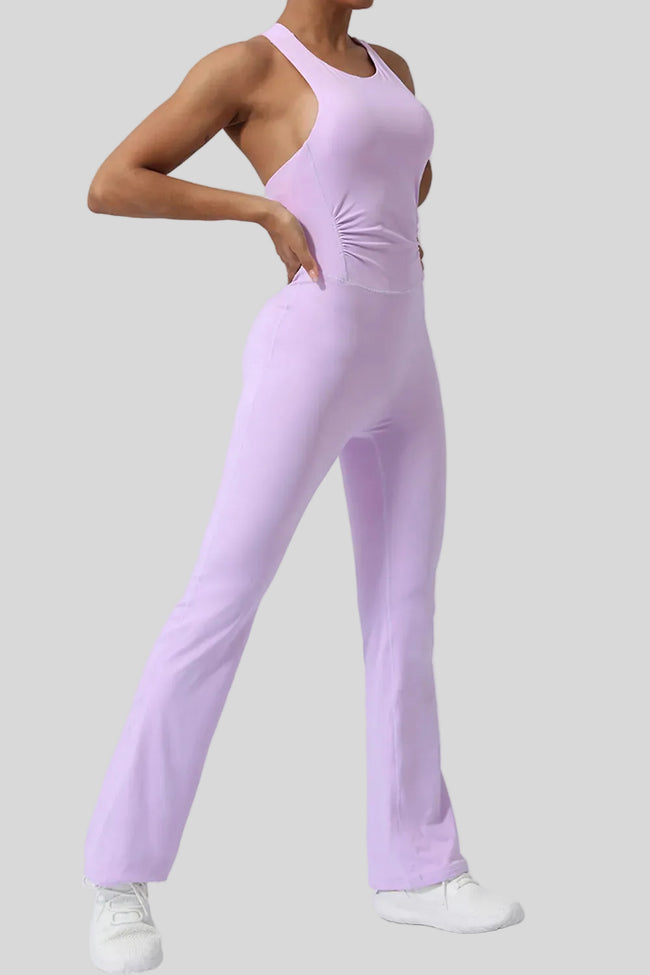 Athlesi StudioCross Sculpt & Flow Jumpsuit in blush pink showing fluid pant silhouette, front angle view