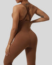Close-up of Athlesi StudioCross Sculpt & Flow Jumpsuit fabric and crisscross back detail in brown