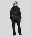 Full body back view of woman wearing Black StudioEase Cropped Hoodie with matching sweatpants