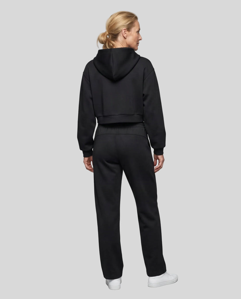 Full body back view of woman wearing Black StudioEase Cropped Hoodie with matching sweatpants