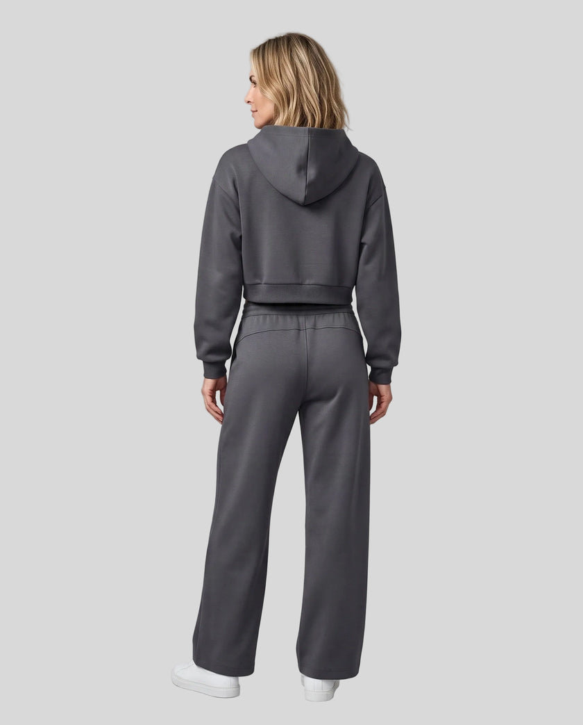 Full body back view of woman wearing Charcoal Gray StudioEase Cropped Hoodie with matching sweatpants