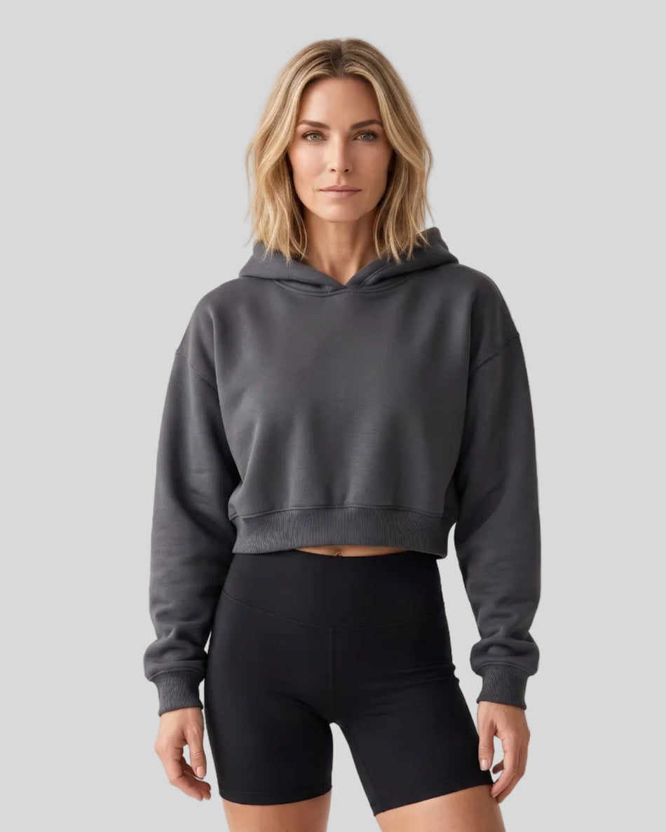 Upper body front view of woman wearing StudioEase Cropped Hoodie in Charcoal Gray