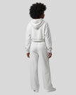 Full body back view of woman wearing Flower Gray StudioEase Cropped Hoodie with matching sweatpants