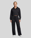 Full body front view of woman styling StudioEase Cropped Zip Hoodie with matching high-waisted sweatpants in Black