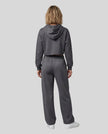 Full body back view of woman wearing charcoal gray StudioEase Cropped Zip Hoodie in a coordinated casual outfit