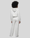 Full body back view of woman wearing flower gray StudioEase Cropped Zip Hoodie in a coordinated casual outfit