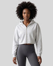 Upper body front view of woman wearing StudioEase Cropped Zip Hoodie zipped closed in Flower Gray