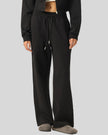 Angled lower body front view of woman wearing StudioEase Straight-Leg Sweatpants showing relaxed fit