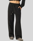 Lower body view of woman wearing StudioEase Straight-Leg Sweatpants with hand resting in side pocket