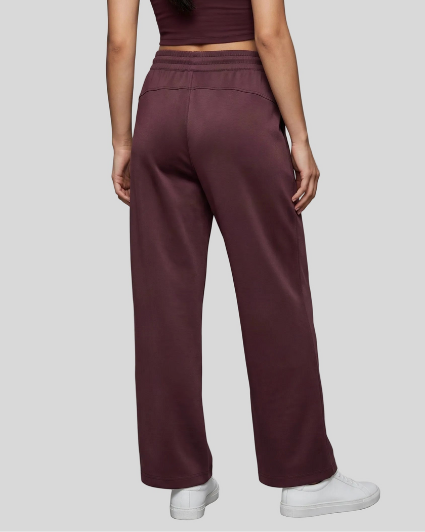 Lower body back view of woman wearing StudioEase Straight-Leg Sweatpants in Dark Reddish Purple