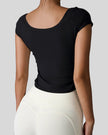 Back view of StudioFlow Short Sleeve Active Top in black with smooth finish