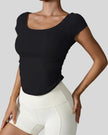 StudioFlow Short Sleeve Active Top in black, front view with fitted silhouette