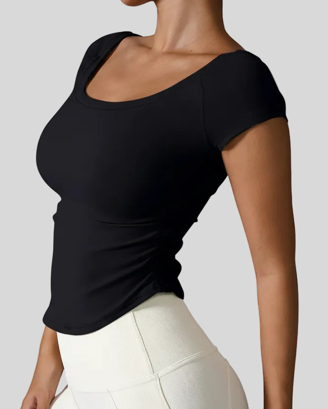 Side view of StudioFlow Short Sleeve Active Top in black showing rouching detail
