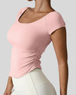 Side view of StudioFlow Short Sleeve Active Top in blush pink showing rouching detail