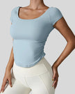 StudioFlow Short Sleeve Active Top in light blue, front view with fitted silhouette