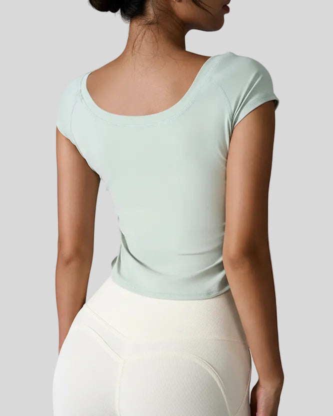 Back view of StudioFlow Short Sleeve Active Top in light green with smooth finish