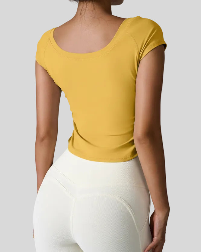Back view of StudioFlow Short Sleeve Active Top in mustard with smooth finish