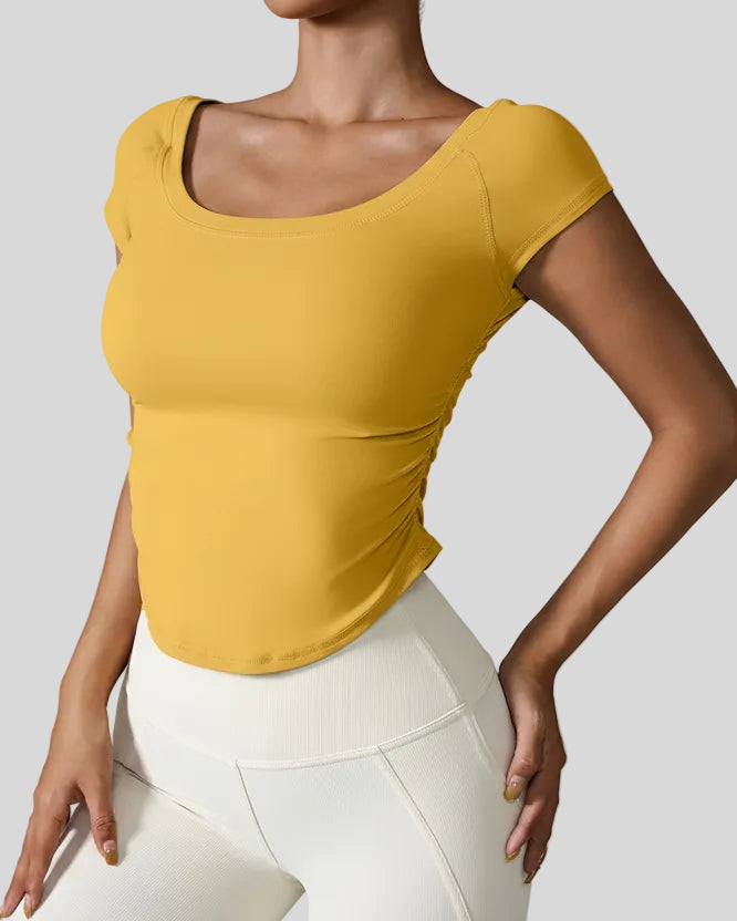 StudioFlow Short Sleeve Active Top in mustard, front view with fitted silhouette