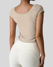 Back view of StudioFlow Short Sleeve Active Top in tan with smooth finish