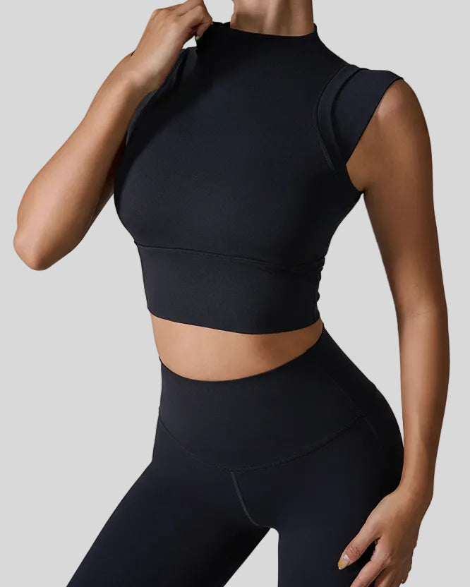 StudioLine High-Neck Tank black, angled view highlighting clean arm openings and smooth fabric