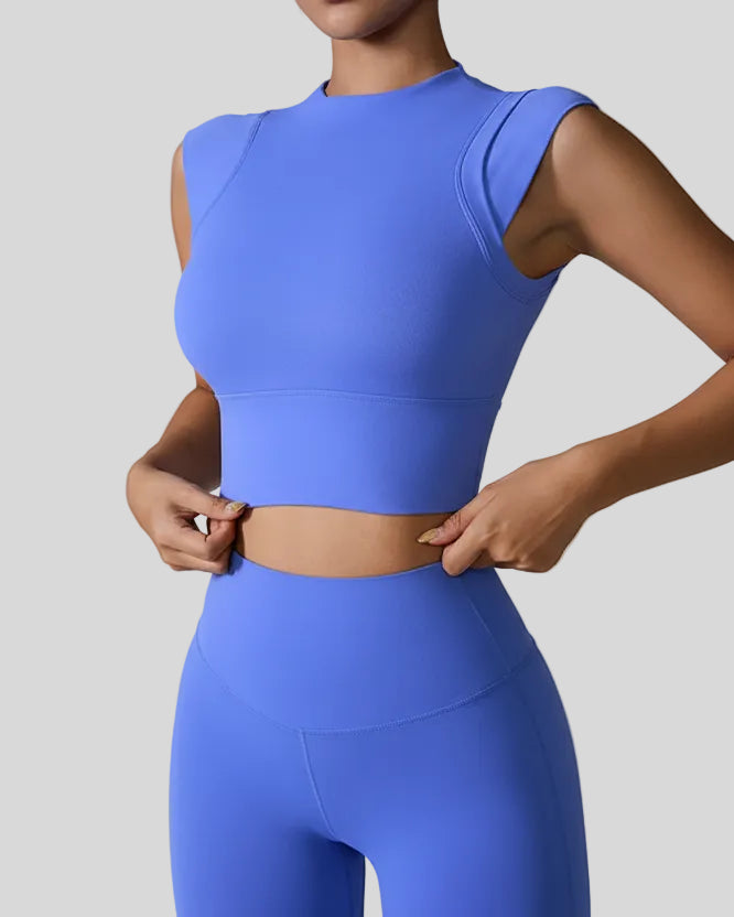 StudioLine High-Neck Tank blue, angled view highlighting clean arm openings and smooth fabric