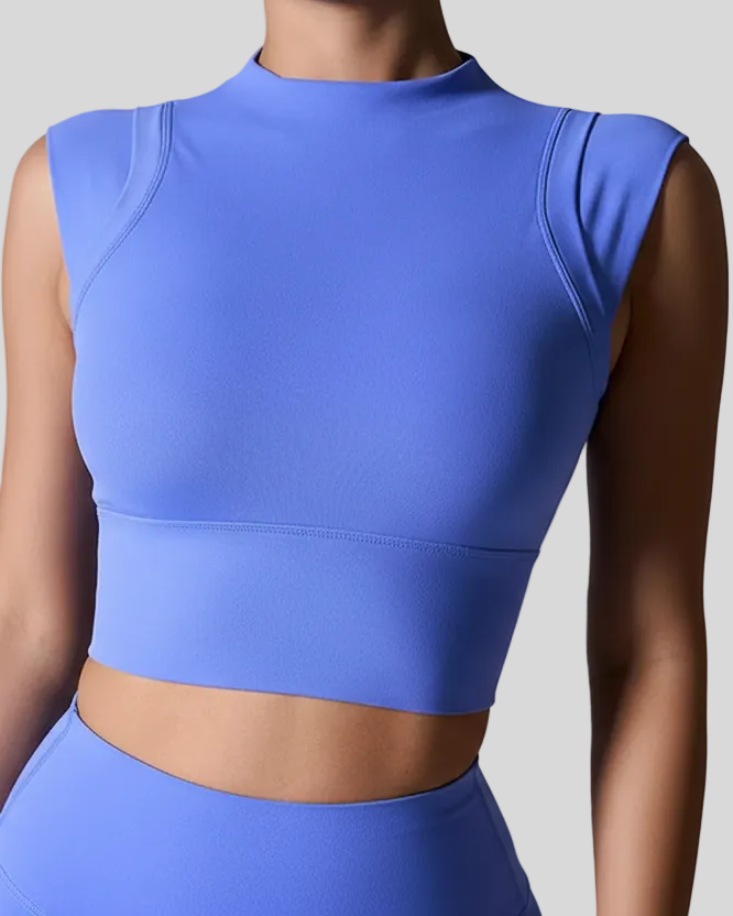 Blue activewear top worn by a woman on a gray background