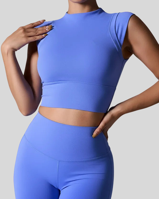 StudioLine High-Neck Tank in blue, front view showing cropped fit and high neckline